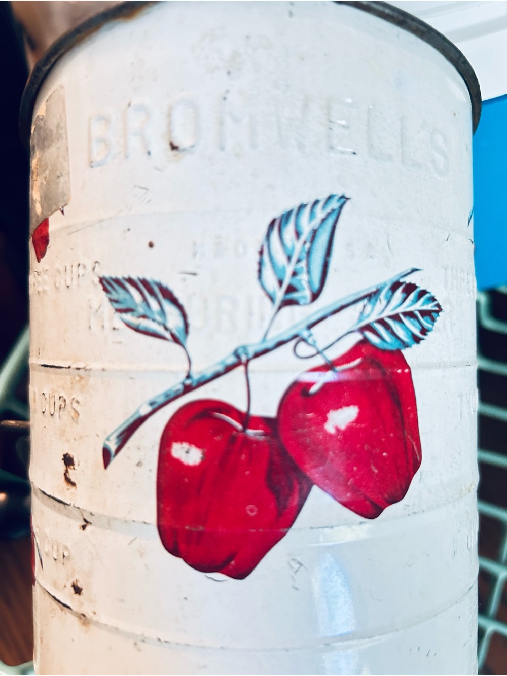 Vintage flour sifter with apple motif